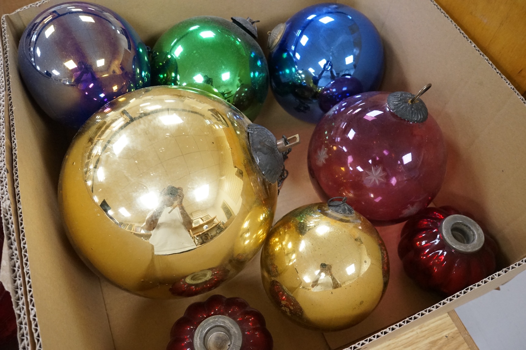 A collection of coloured circular and grape shaped glass witches balls and decorations, largest grape decoration 40cm in length